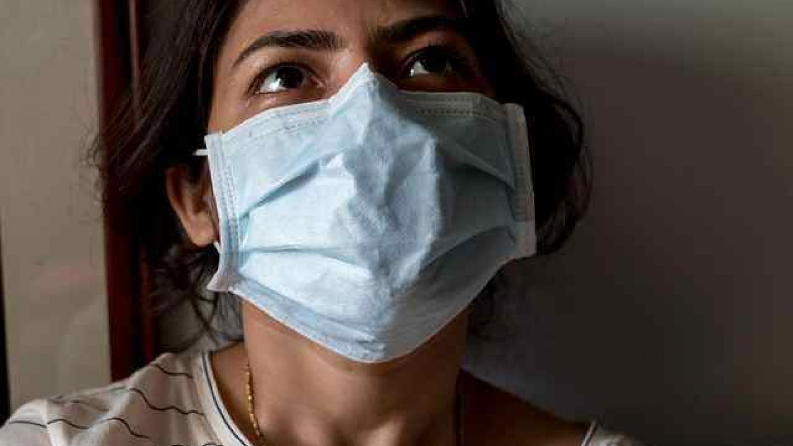 A female health professional wearing a mask