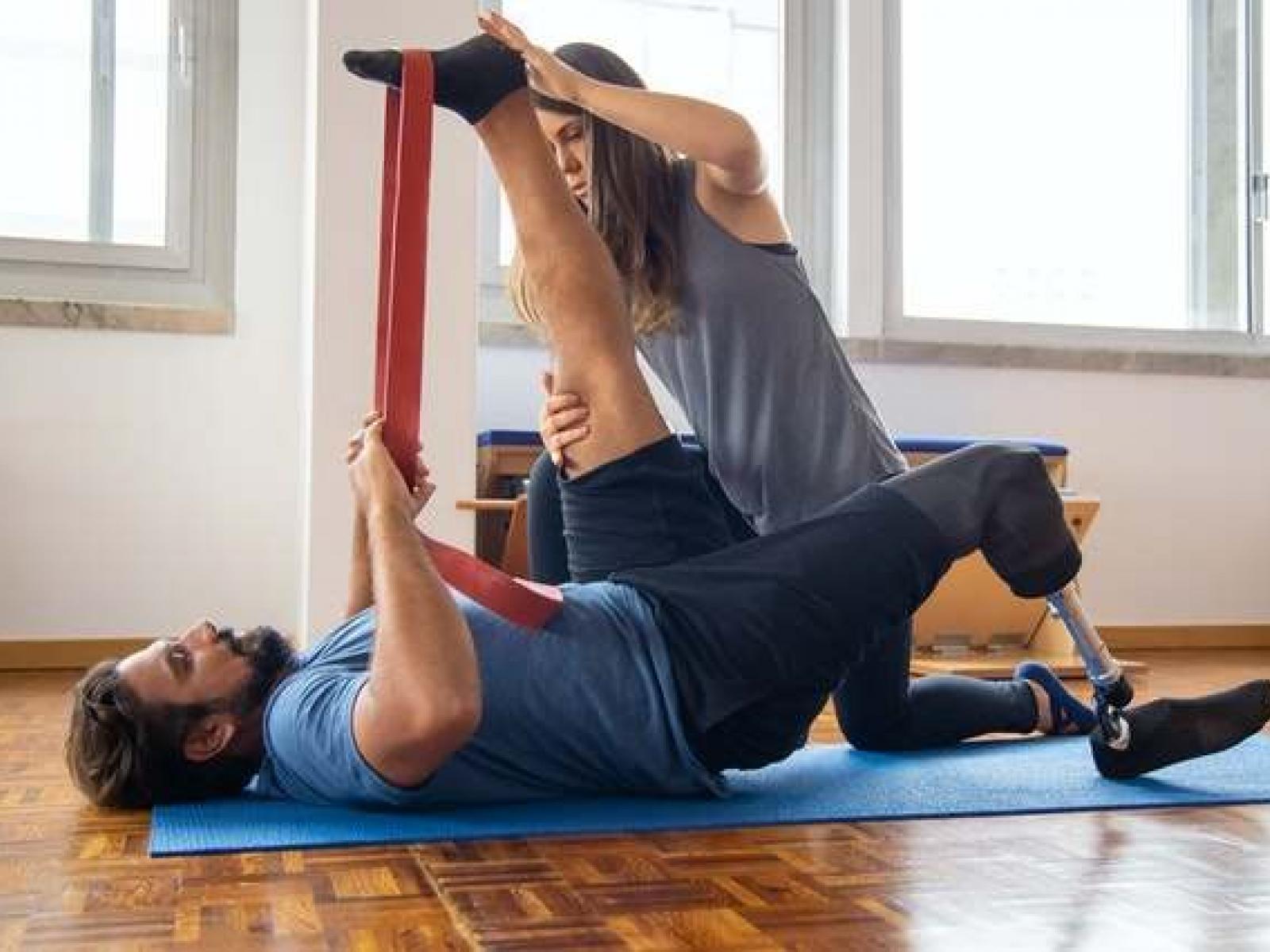 A physiotherapist working with a patient